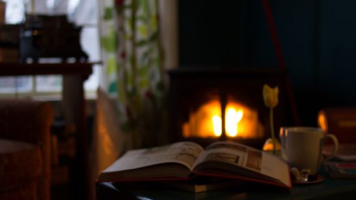 Reading by a fireplace