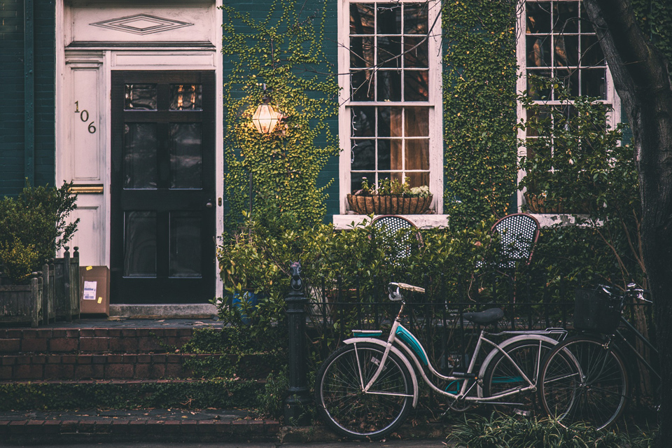 A vintage bicycle in front of a home