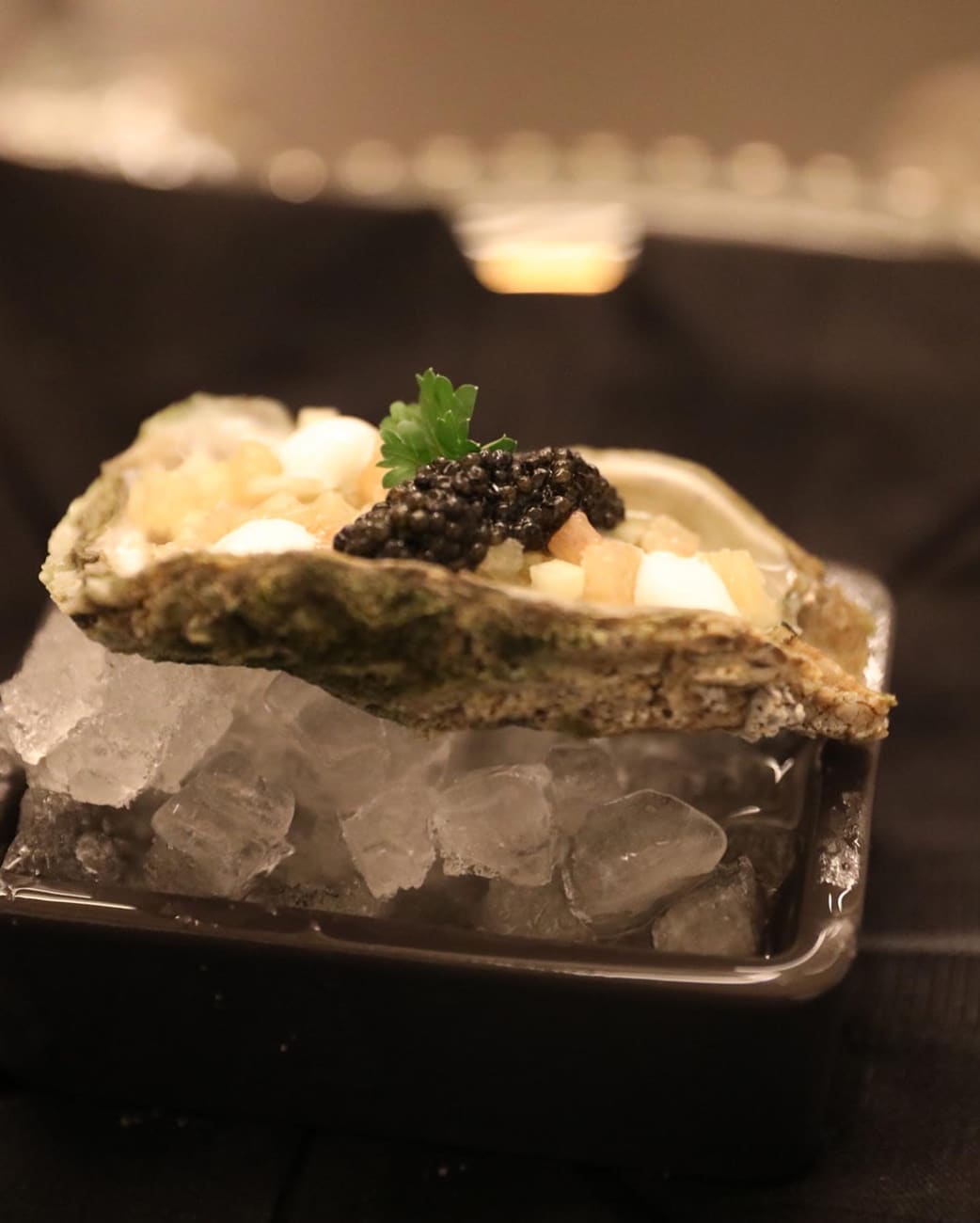 Oyster with Pink Grapefruit, Goat Cheese, Cucumber, and Caviar