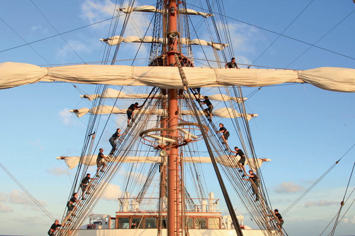 Staff raising the sails on a Lindblad Expeditions ship