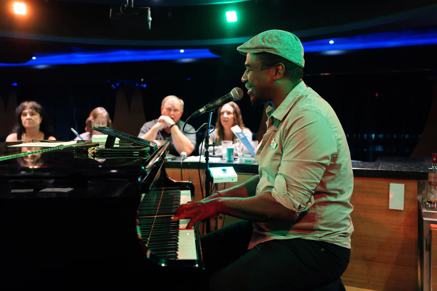 Carnival Magic's piano man, Josh Mille singing to his loyal cruise fans