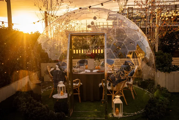 Heated Igloos and Festive Feasts Await at 1864 Rooftop Bar & Kitchen