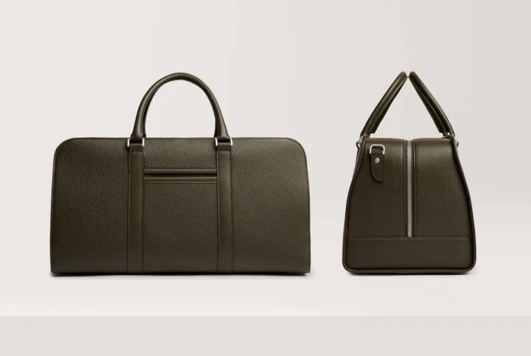 Palissy Weekend Bag in Taupe leather on a wooden surface