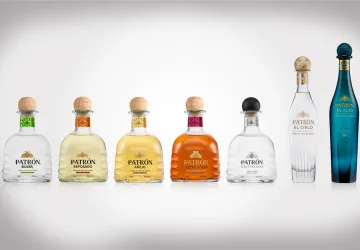 Lineup of Patrón Tequila bottles showcasing the new 2025 packaging redesign, featuring embossed agave detail and gold bee emblem