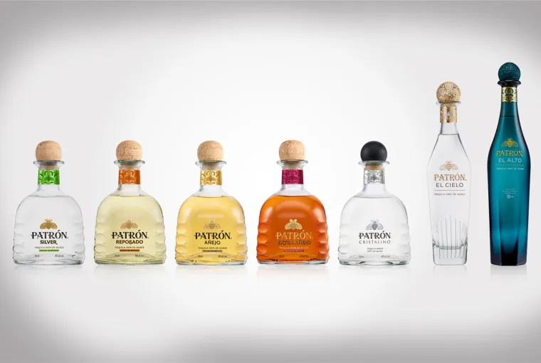 Lineup of Patrón Tequila bottles showcasing the new 2025 packaging redesign, featuring embossed agave detail and gold bee emblem