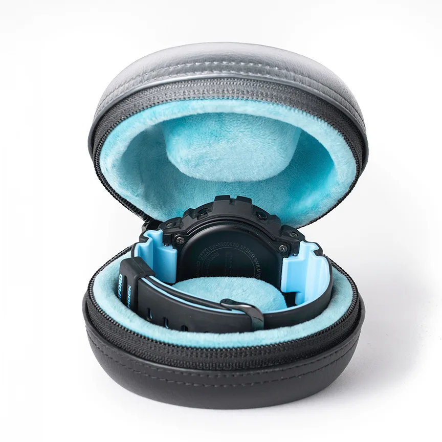 Discommon Goods The Puck leather watch travel case in black, open to reveal protective interior