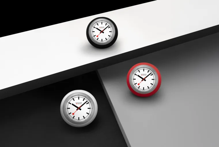 Mondaine Globe Clock displayed on a modern desk showcasing its Swiss minimalist design