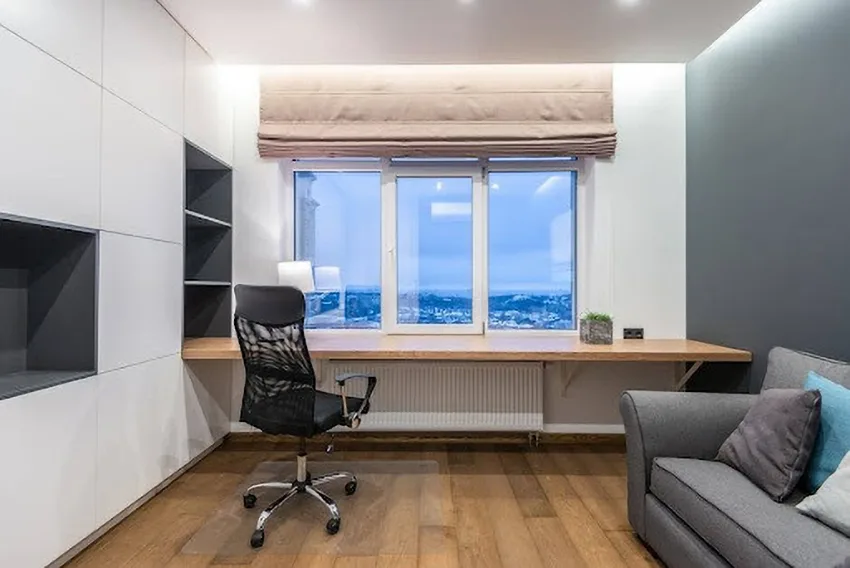 A modern apartment home office with city views