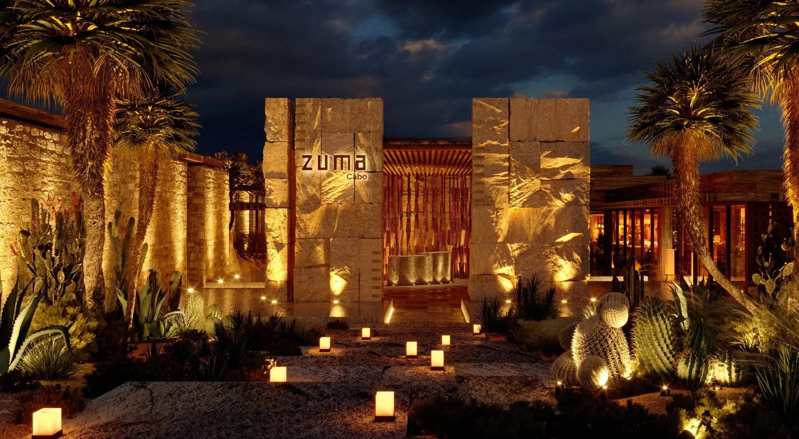 Zuma Cabo restaurant entrance at night with illuminated stone walls and ZUMA Cabo signage