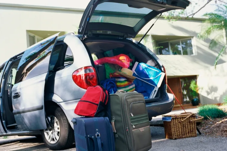 Suitcases and bags packed into the back of a car ready for a weekend trip