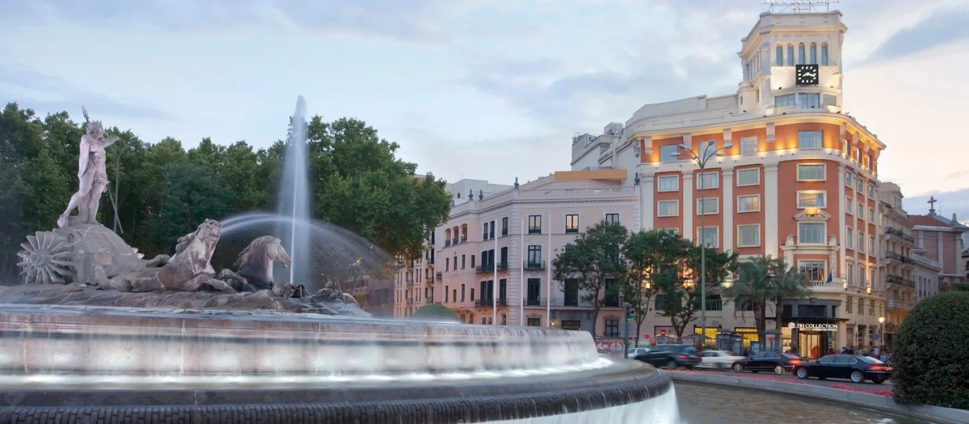 Neptune Fountain on the Paseo del Prado in Madrid at dusk