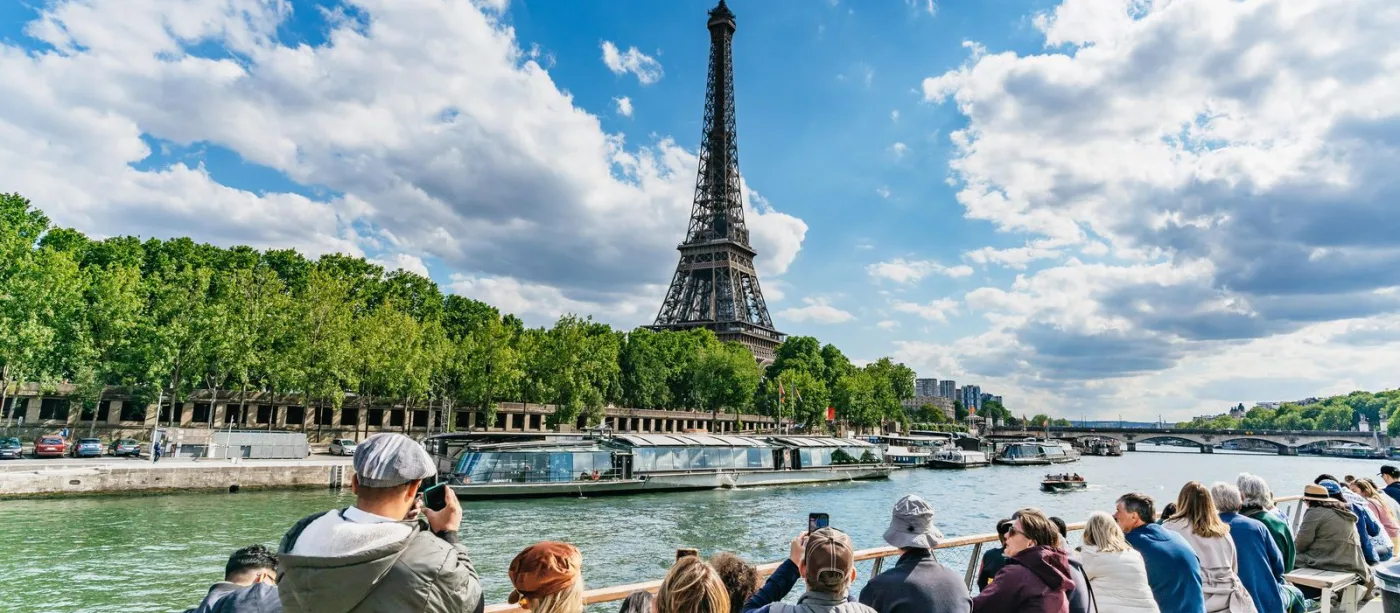 Sightseeing boat on the Seine with the Eiffel Tower in Paris