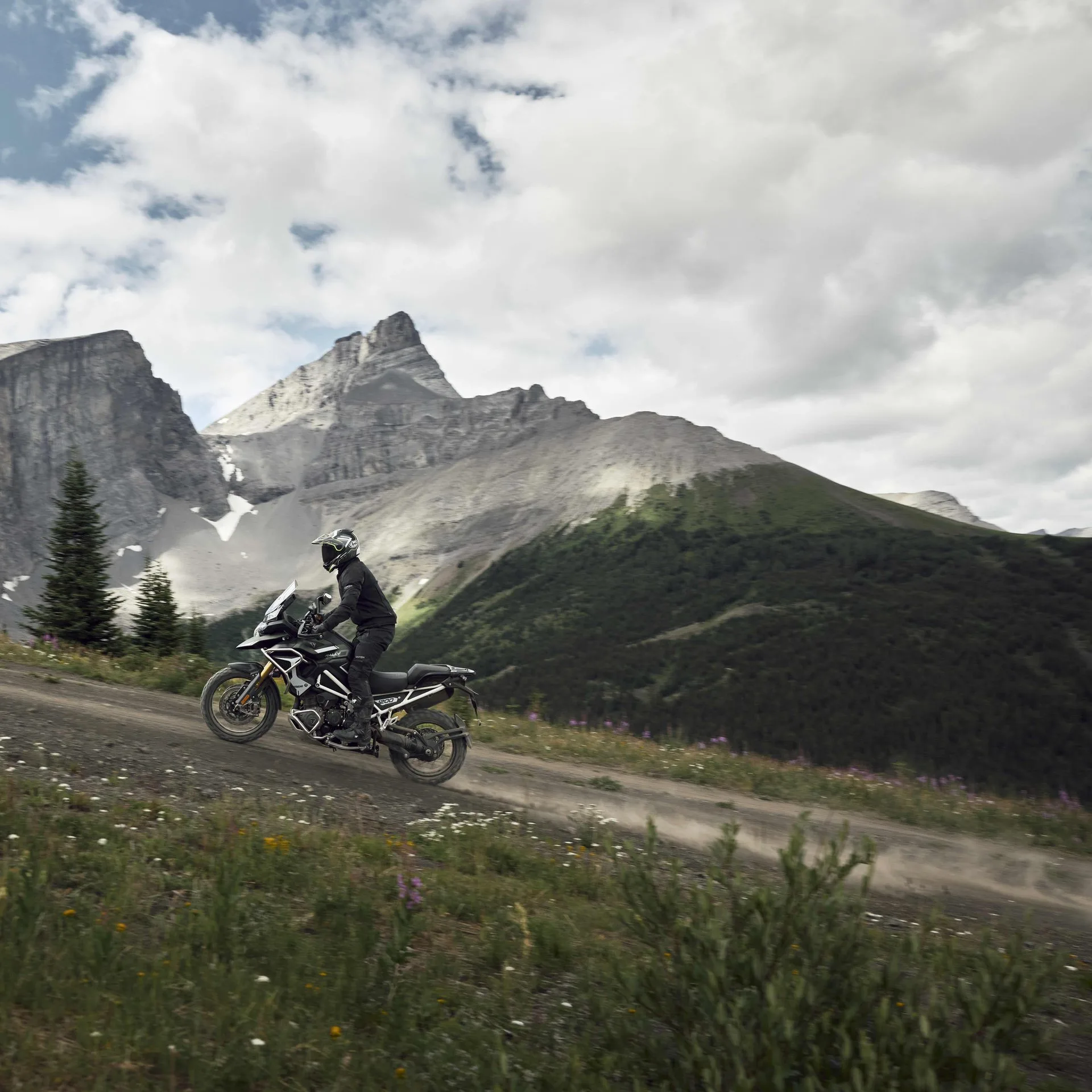 2027 Triumph Tiger 1200 Rally Pro riding a dirt track in the mountains