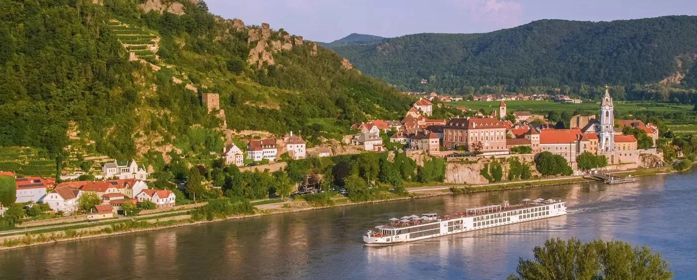 Viking longship on the Danube at sunset passing Durnstein A Viking longship on the Danube at sunset passing Dürnstein